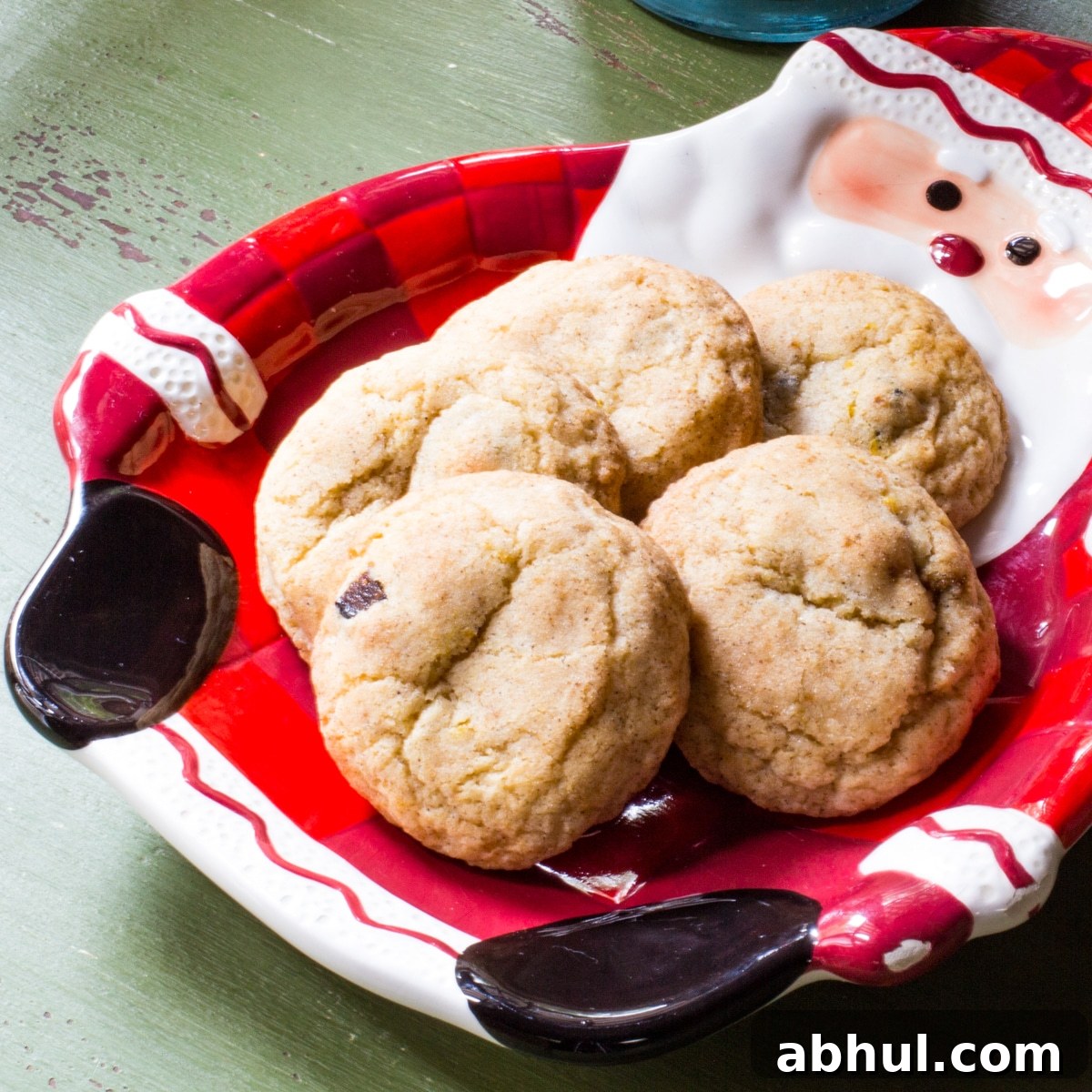 Several snickerdoodle cookies with figs on a Santa cookie plate.