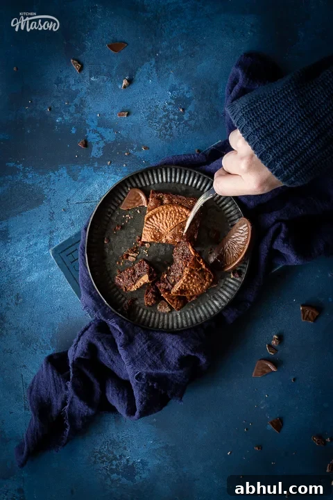 Someone forking Fudgy orange brownies on a plate