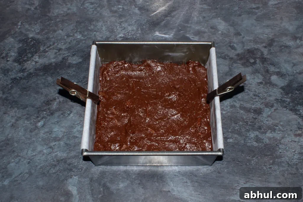 Chocolate orange brownie batter in a lined tin
