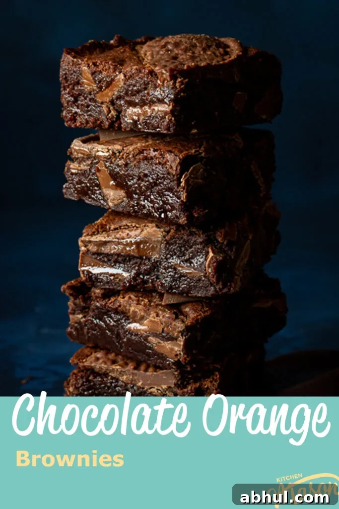 Close up of Terry's chocolate orange brownies in a stack. A text overlay says 