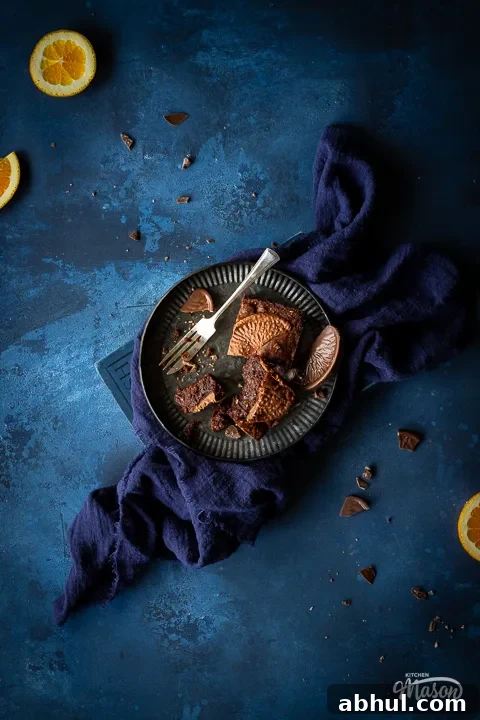 Partially eaten Terry's chocolate orange brownies on a plate with a fork