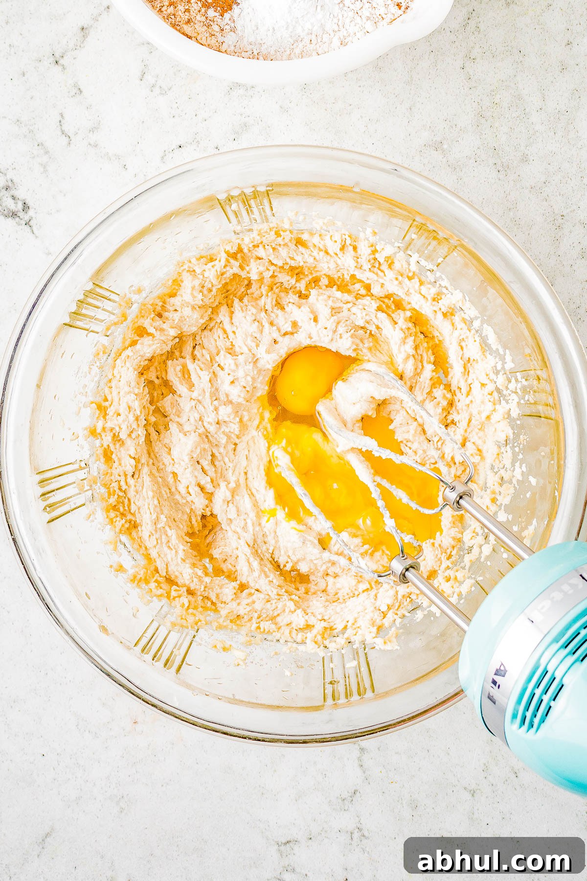 Beating eggs into cookie dough